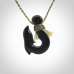 These pendants are hand carved, black jade hooks or matau pendants. They are beautifully finished in a high polish and bound with a khaki necklace cord.