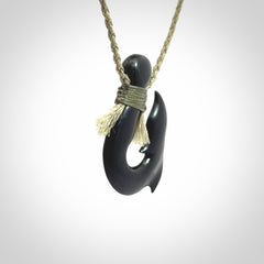 These pendants are hand carved, black jade hooks or matau pendants. They are beautifully finished in a high polish and bound with a khaki necklace cord.