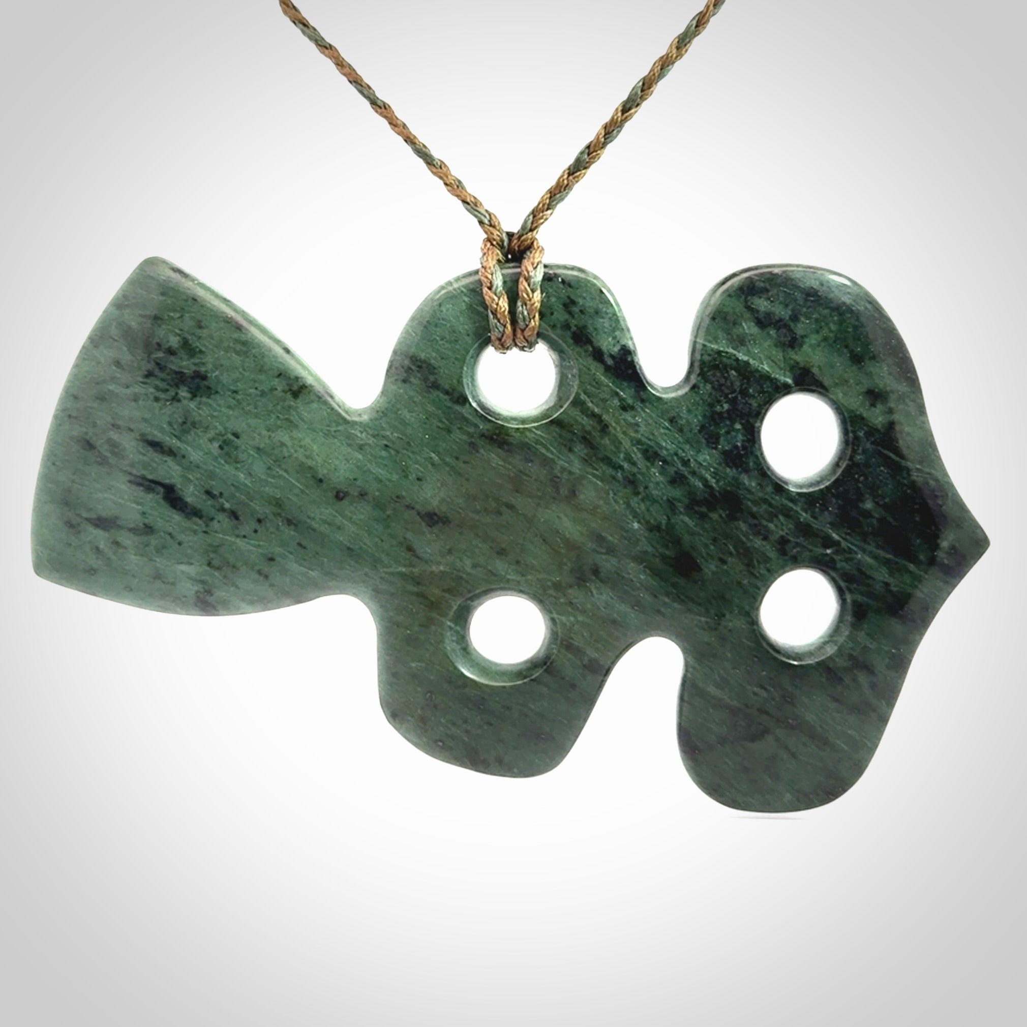 This is a large hand carved New Zealand Jade tiki pendant. It is made from New Zealand Jade and Paua shell.