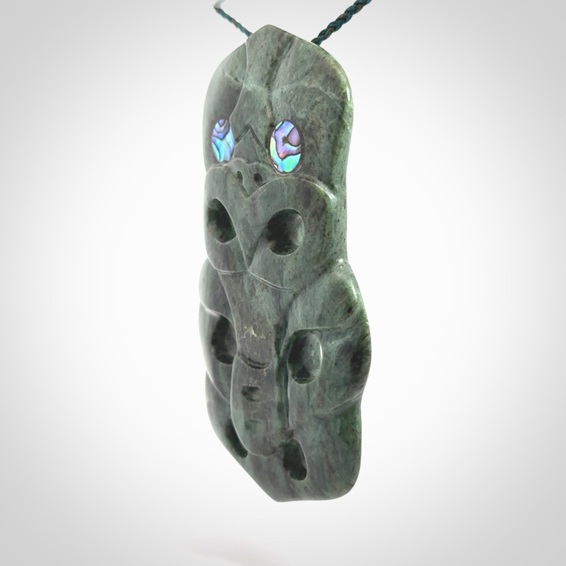 This is a large hand carved New Zealand Jade tiki pendant. It is made from New Zealand Jade and Paua shell.
