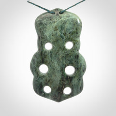 This is a large hand carved New Zealand Jade tiki pendant. It is made from New Zealand Jade and Paua shell.