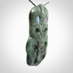 This is a large hand carved New Zealand Jade tiki pendant. It is made from New Zealand Jade and Paua shell.