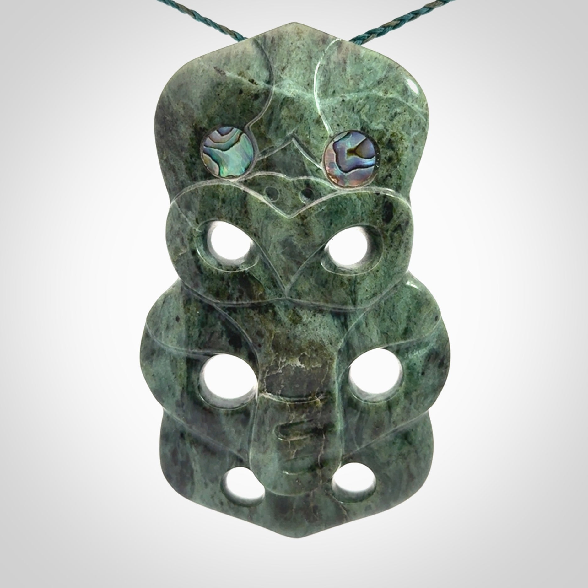 This is a large hand carved New Zealand Jade tiki pendant. It is made from New Zealand Jade and Paua shell.