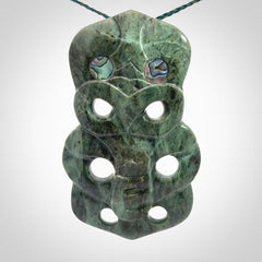 This is a large hand carved New Zealand Jade tiki pendant. It is made from New Zealand Jade and Paua shell.