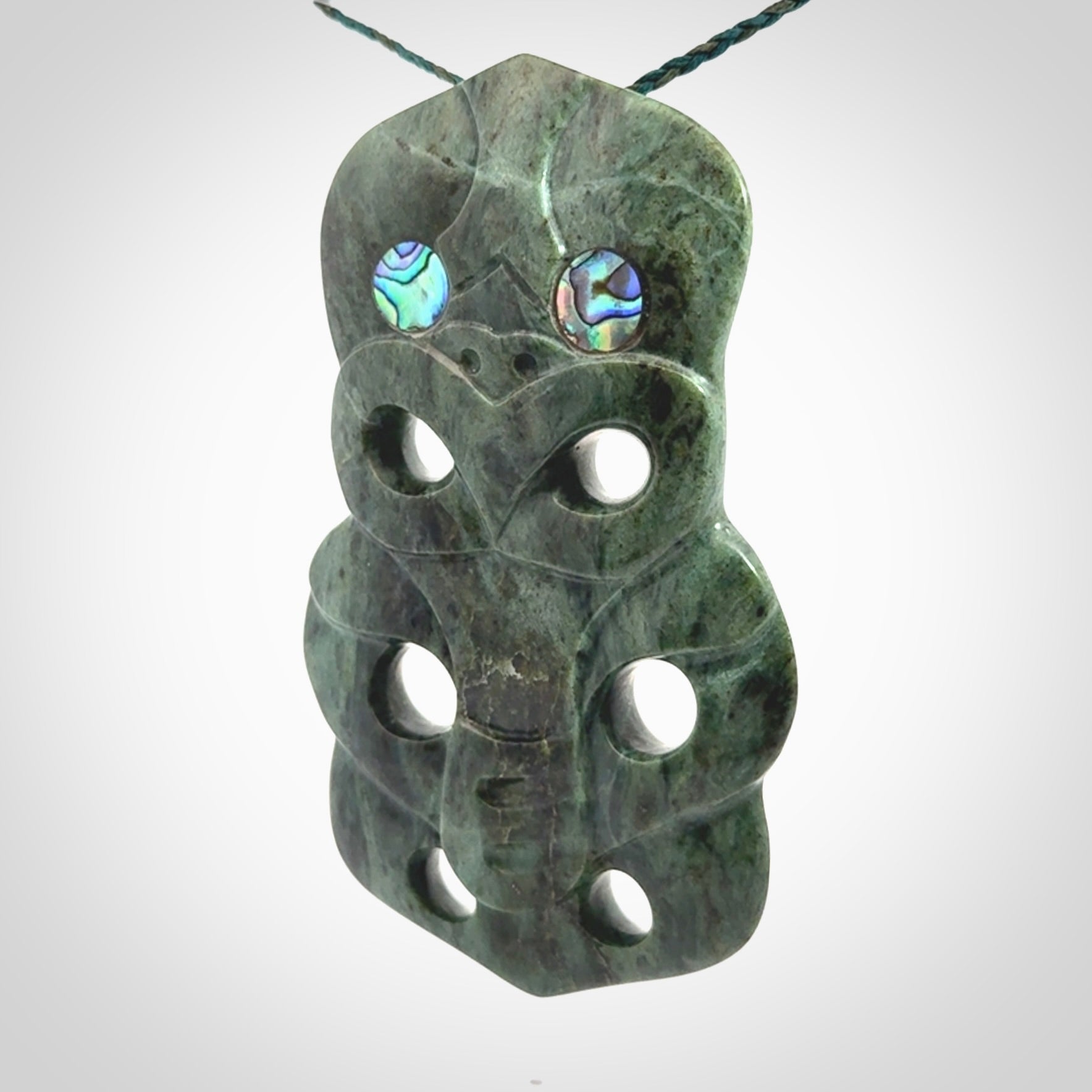 This is a large hand carved New Zealand Jade tiki pendant. It is made from New Zealand Jade and Paua shell.