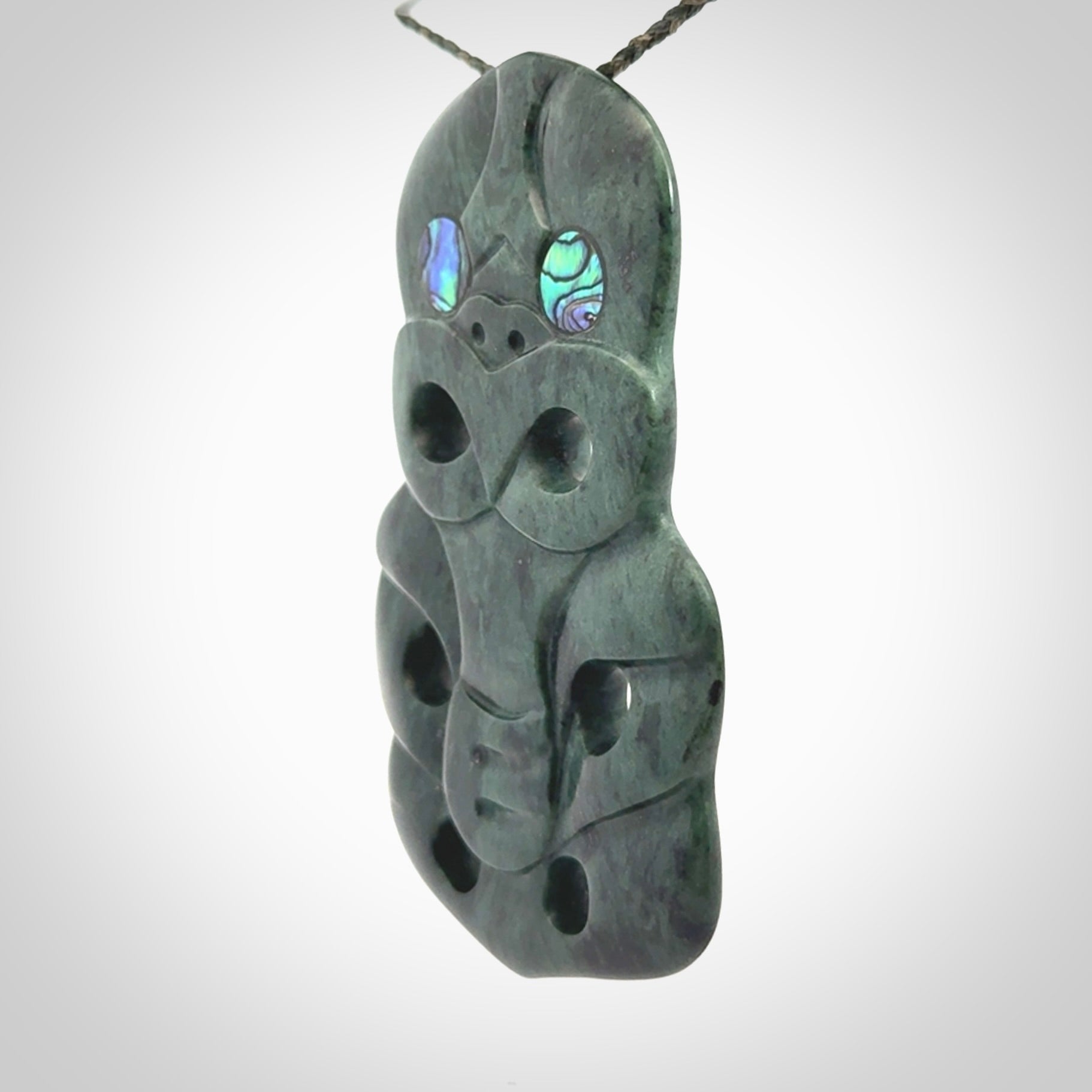 This is a large hand carved New Zealand Jade tiki pendant. It is made from New Zealand Jade and Paua shell.