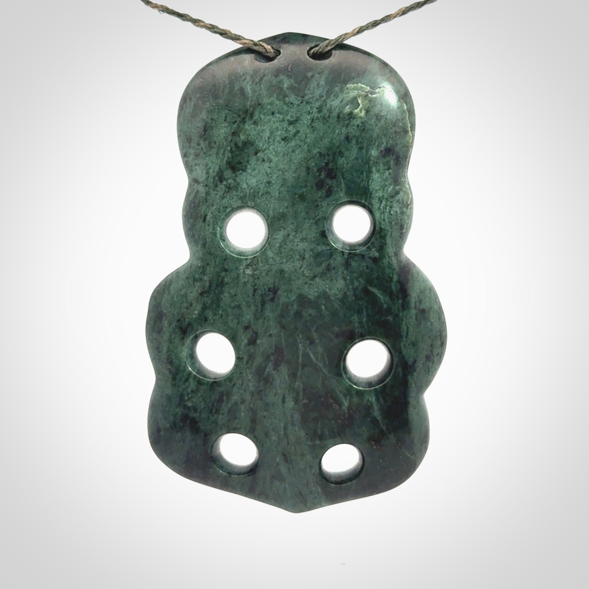 This is a large hand carved New Zealand Jade tiki pendant. It is made from New Zealand Jade and Paua shell.