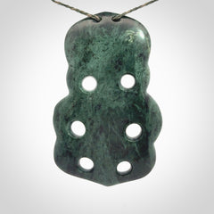 This is a large hand carved New Zealand Jade tiki pendant. It is made from New Zealand Jade and Paua shell.