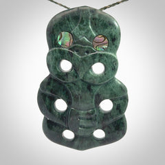 This is a large hand carved New Zealand Jade tiki pendant. It is made from New Zealand Jade and Paua shell.