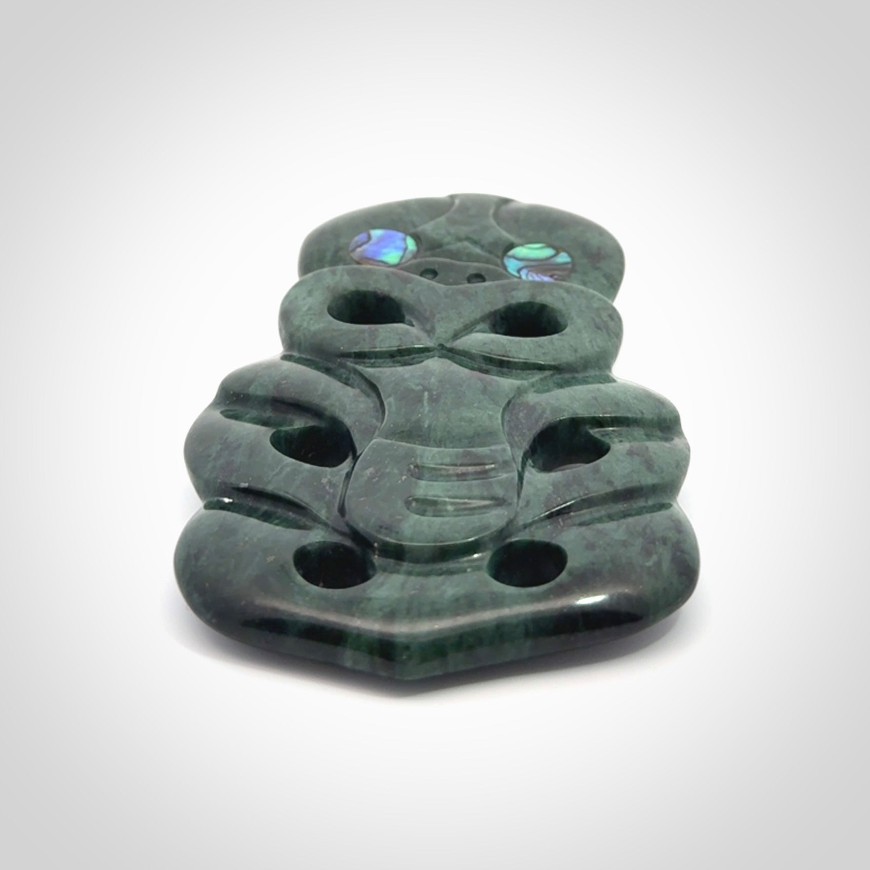 This is a large hand carved New Zealand Jade tiki pendant. It is made from New Zealand Jade and Paua shell.