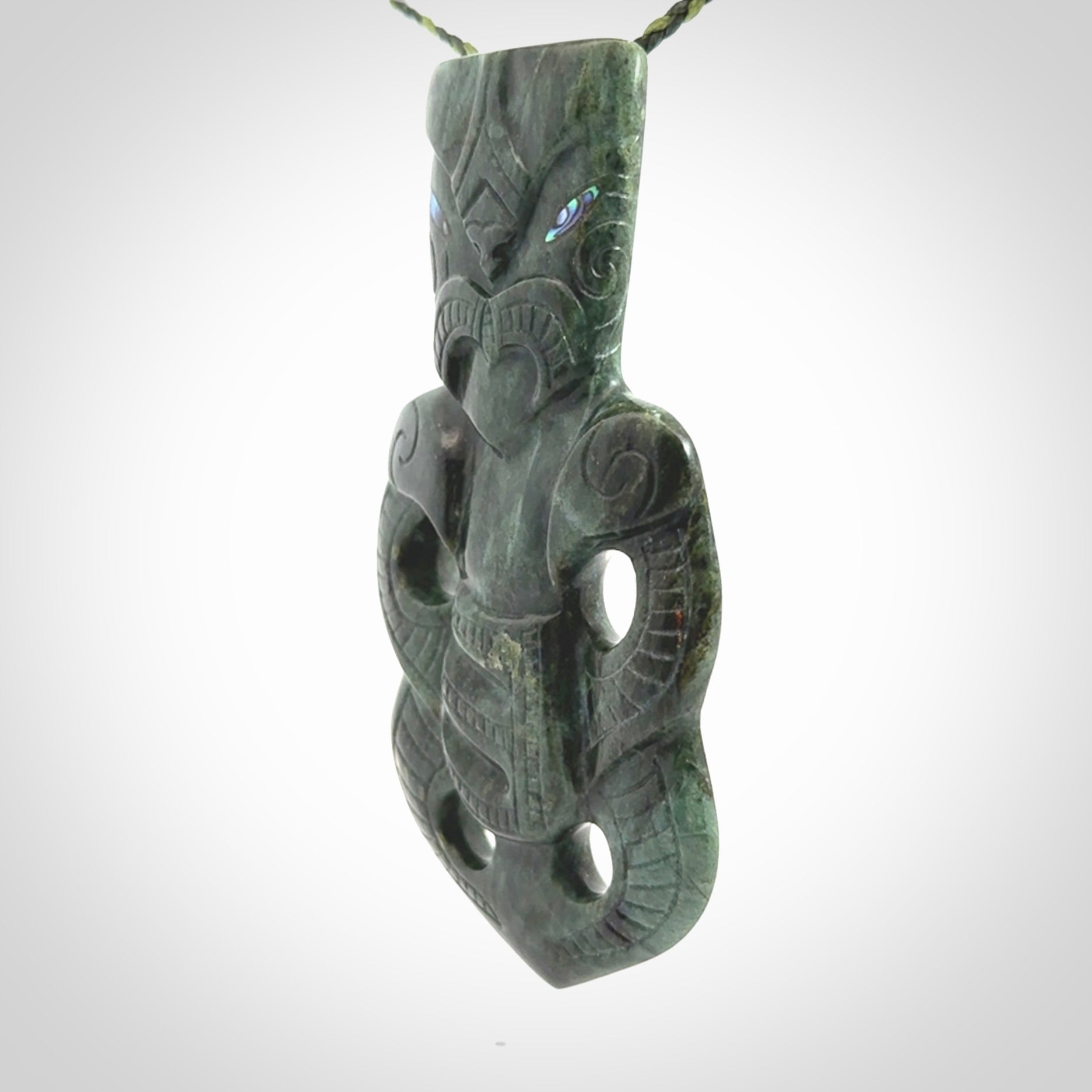 This is a large hand carved New Zealand Jade tiki pendant. It is made from New Zealand Jade and Paua shell.