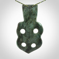 This is a large hand carved New Zealand Jade tiki pendant. It is made from New Zealand Jade and Paua shell.