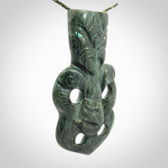 This is a large hand carved New Zealand Jade tiki pendant. It is made from New Zealand Jade and Paua shell.