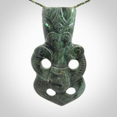 This is a large hand carved New Zealand Jade tiki pendant. It is made from New Zealand Jade and Paua shell.