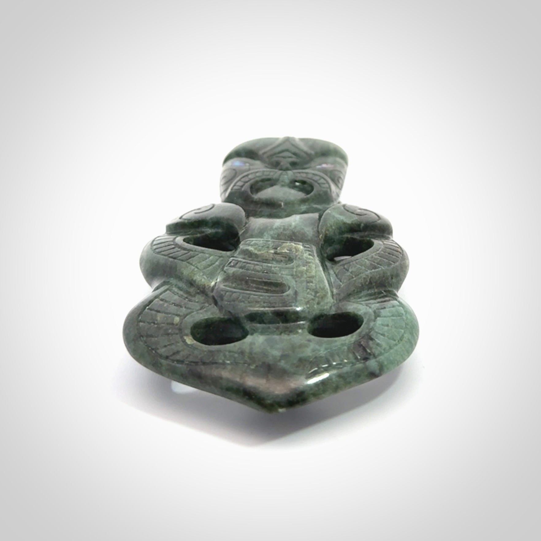This is a large hand carved New Zealand Jade tiki pendant. It is made from New Zealand Jade and Paua shell.