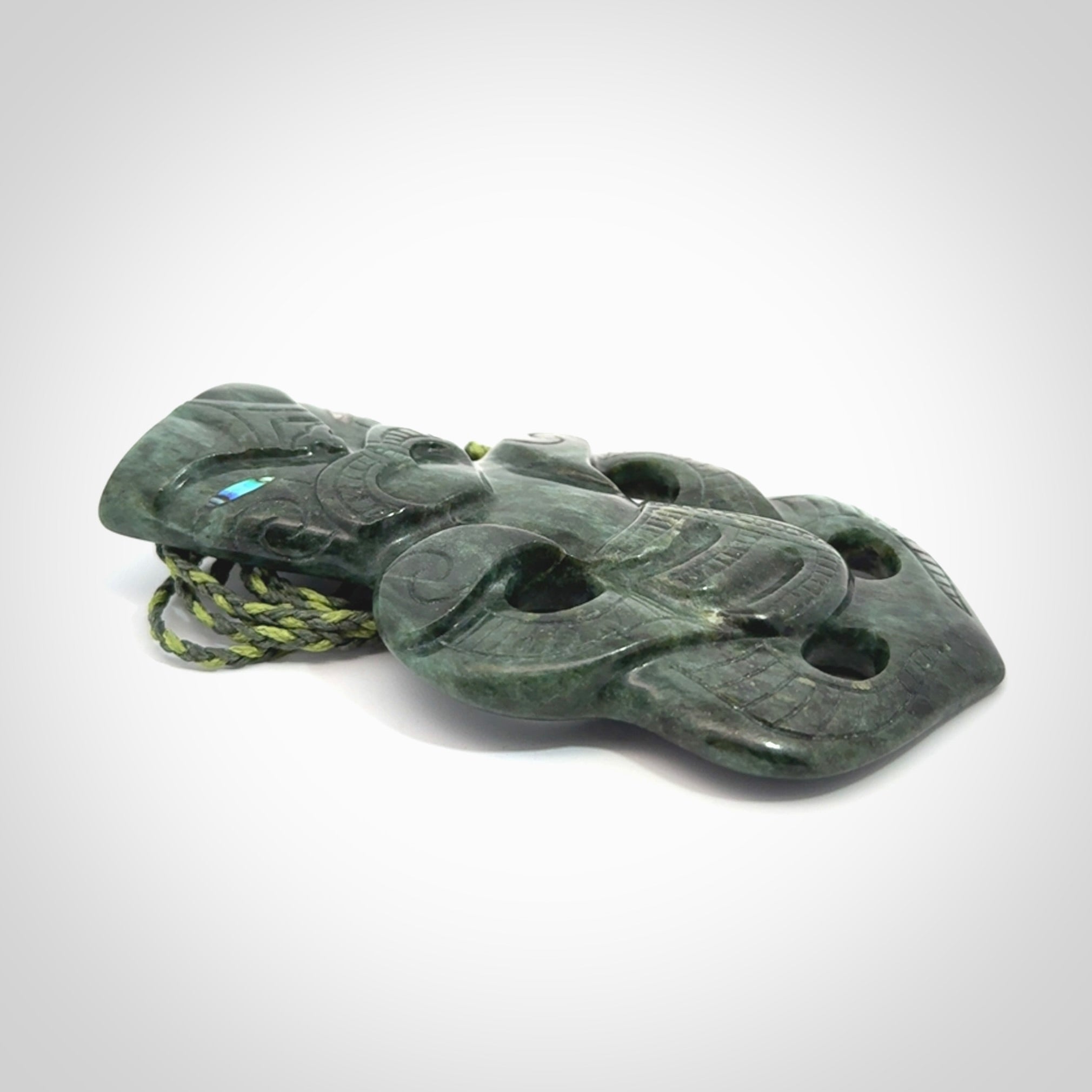 This is a large hand carved New Zealand Jade tiki pendant. It is made from New Zealand Jade and Paua shell.