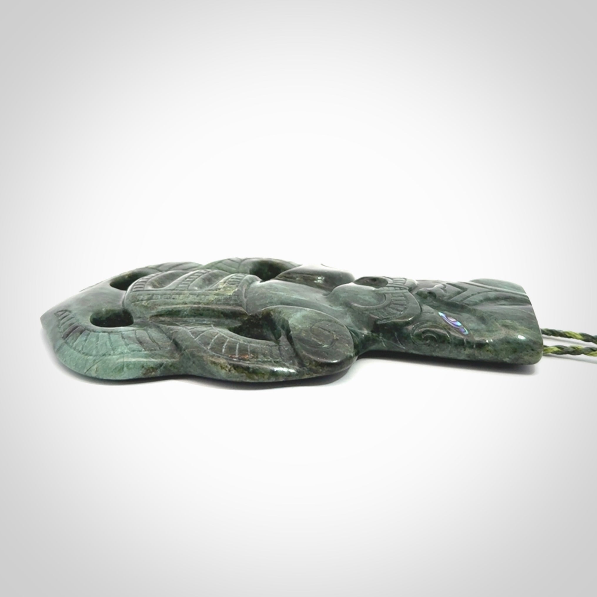 This is a large hand carved New Zealand Jade tiki pendant. It is made from New Zealand Jade and Paua shell.