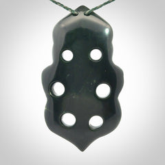This is a large hand carved New Zealand Jade tiki pendant. It is made from New Zealand Jade and Paua shell.