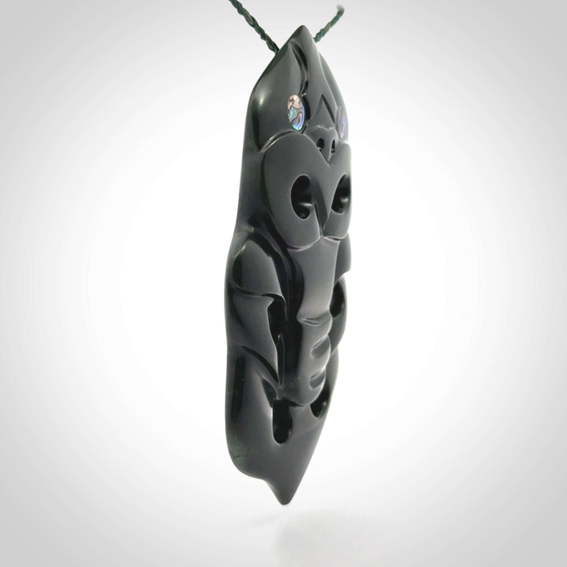 This is a large hand carved New Zealand Jade tiki pendant. It is made from New Zealand Jade and Paua shell.