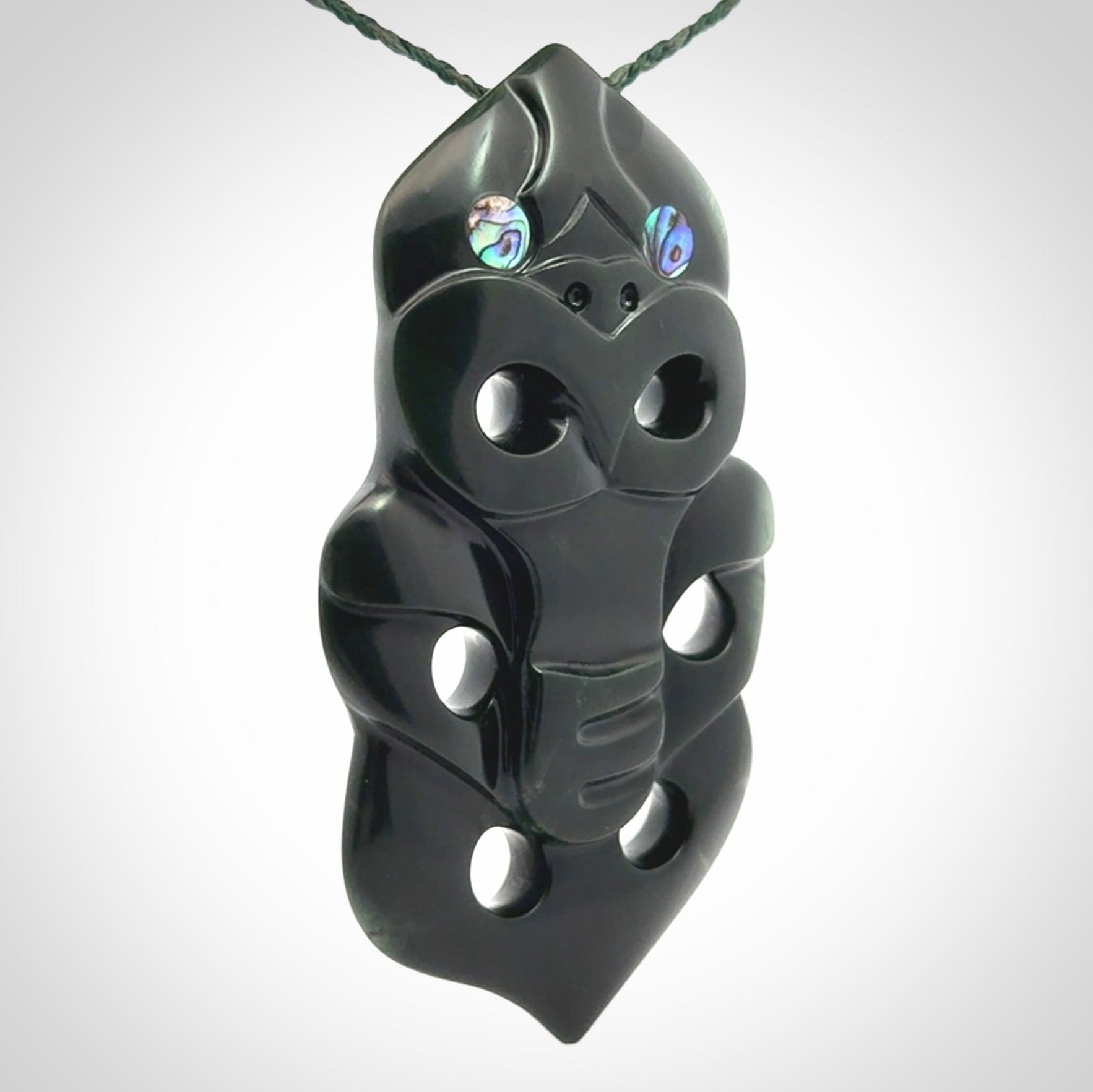 This is a large hand carved New Zealand Jade tiki pendant. It is made from New Zealand Jade and Paua shell.