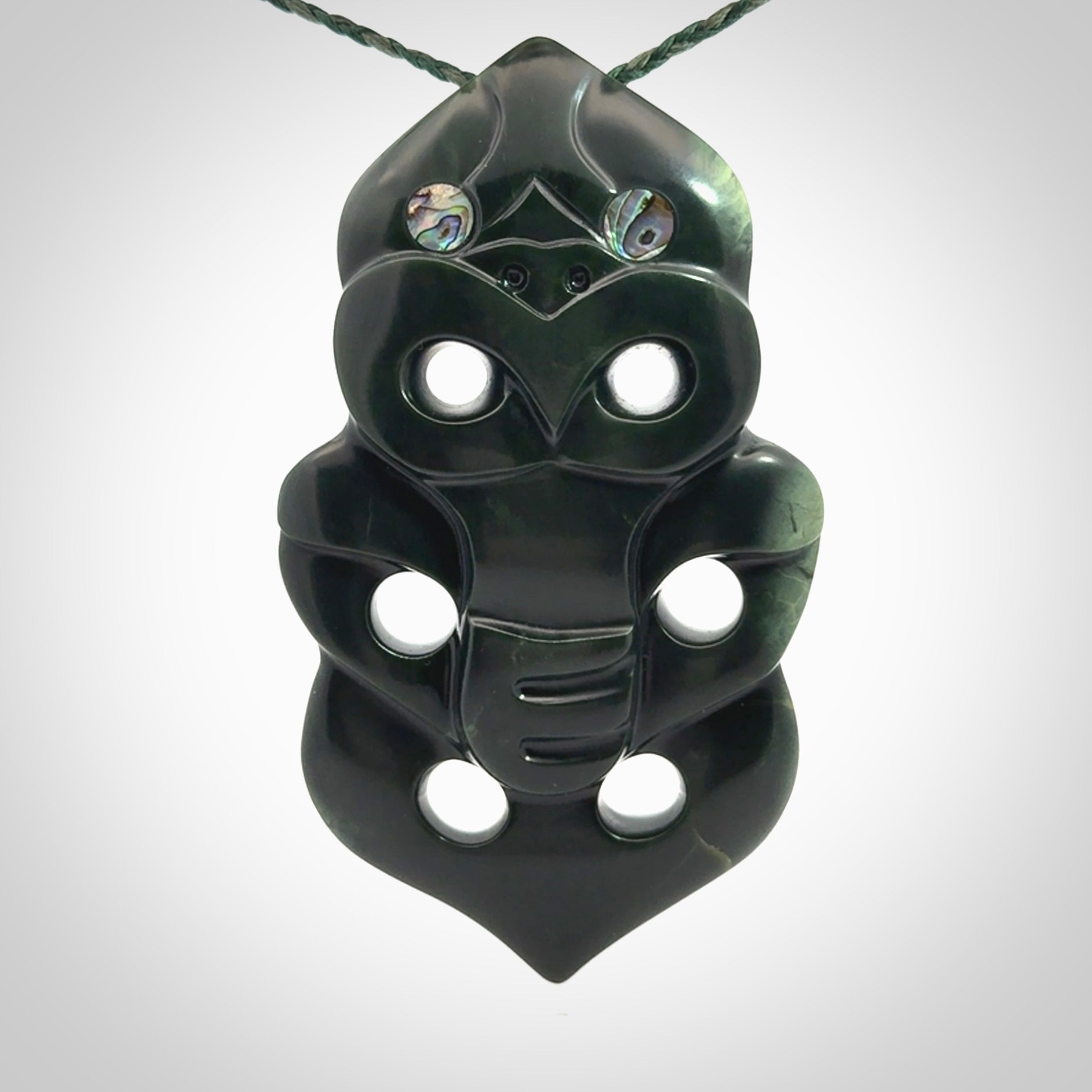 This is a large hand carved New Zealand Jade tiki pendant. It is made from New Zealand Jade and Paua shell.
