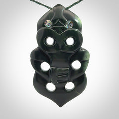 This is a large hand carved New Zealand Jade tiki pendant. It is made from New Zealand Jade and Paua shell.