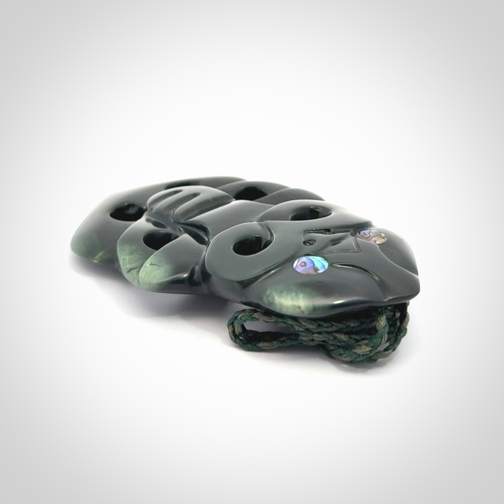 This is a large hand carved New Zealand Jade tiki pendant. It is made from New Zealand Jade and Paua shell.