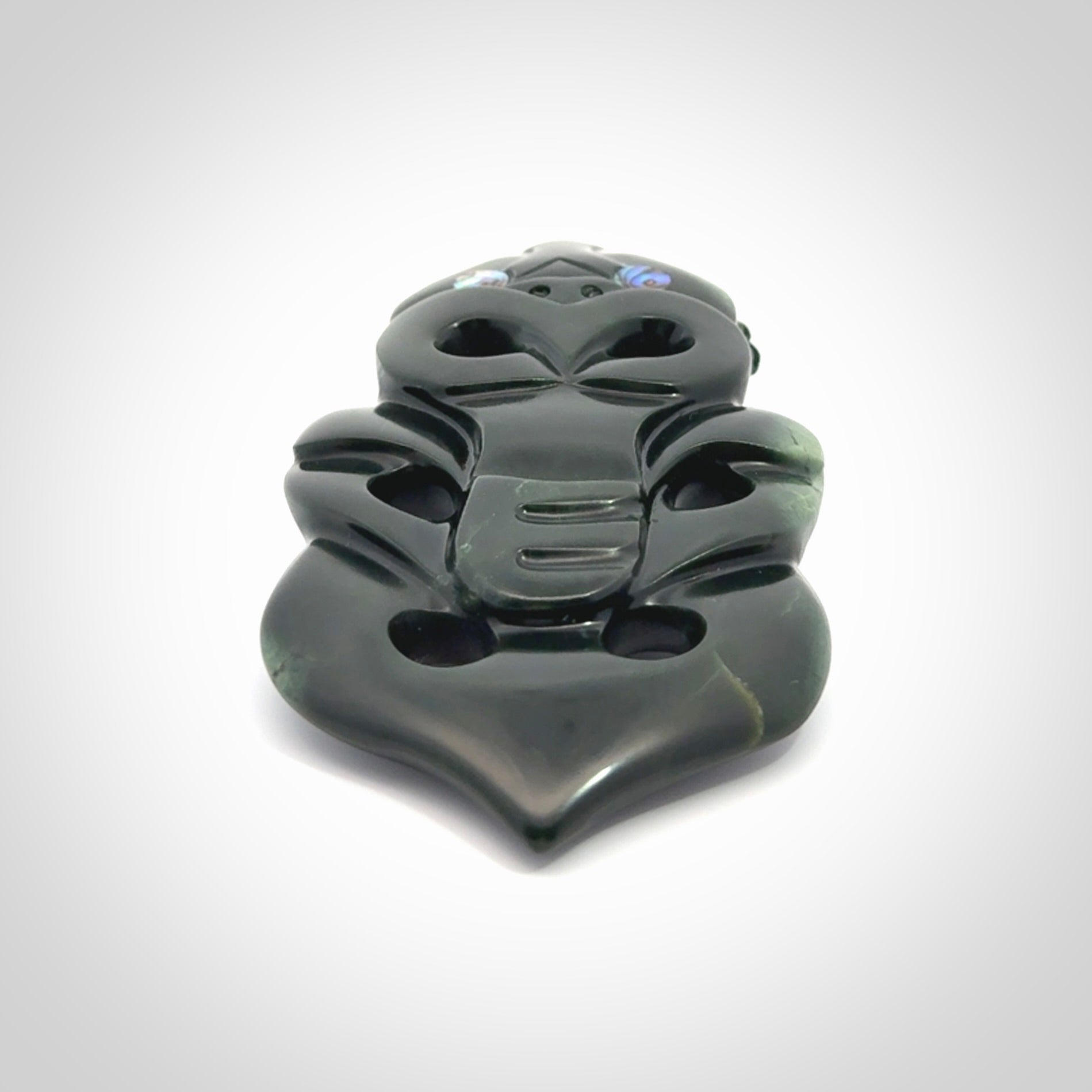 This is a large hand carved New Zealand Jade tiki pendant. It is made from New Zealand Jade and Paua shell.