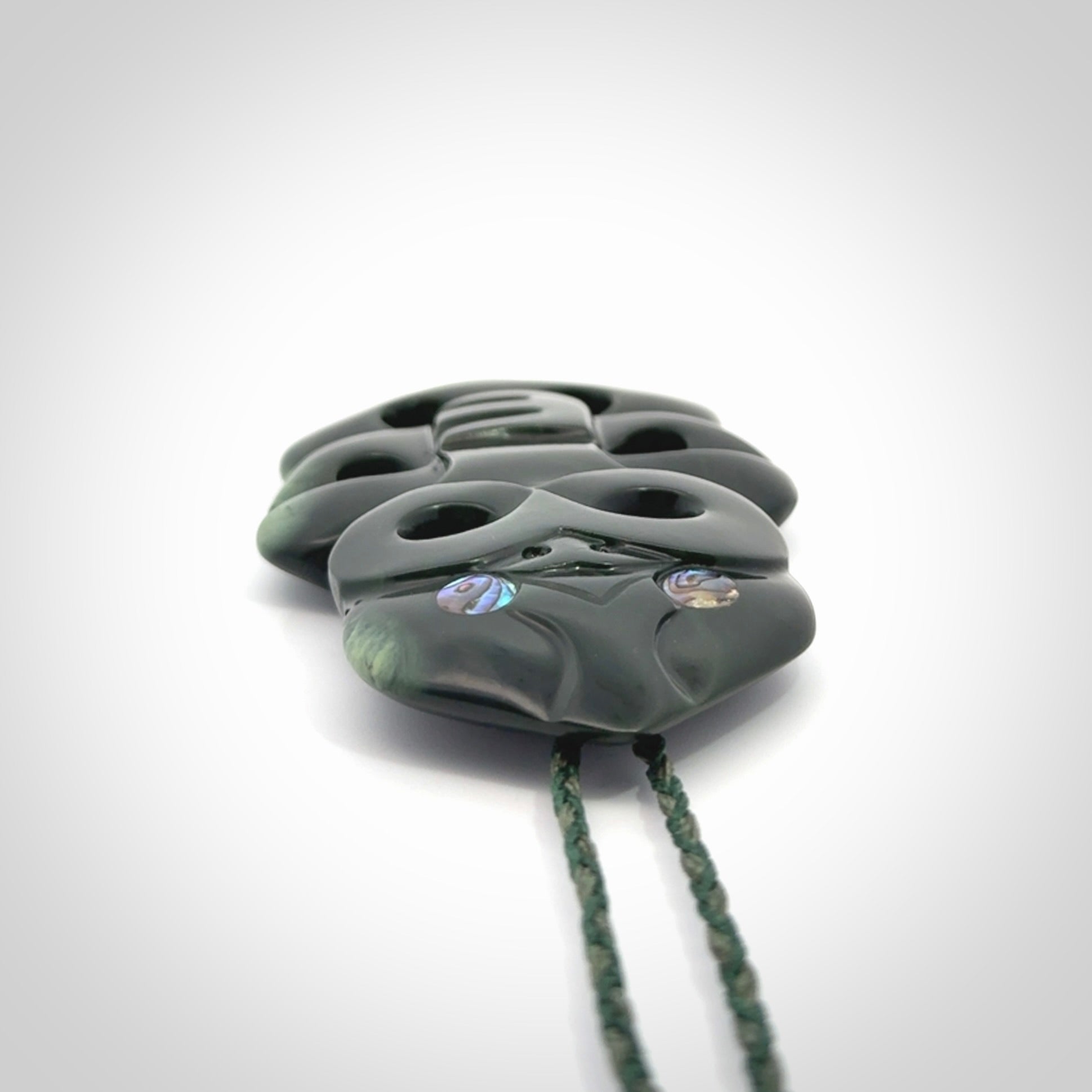 This is a large hand carved New Zealand Jade tiki pendant. It is made from New Zealand Jade and Paua shell.