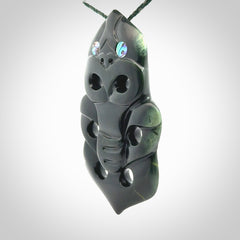 This is a large hand carved New Zealand Jade tiki pendant. It is made from New Zealand Jade and Paua shell.
