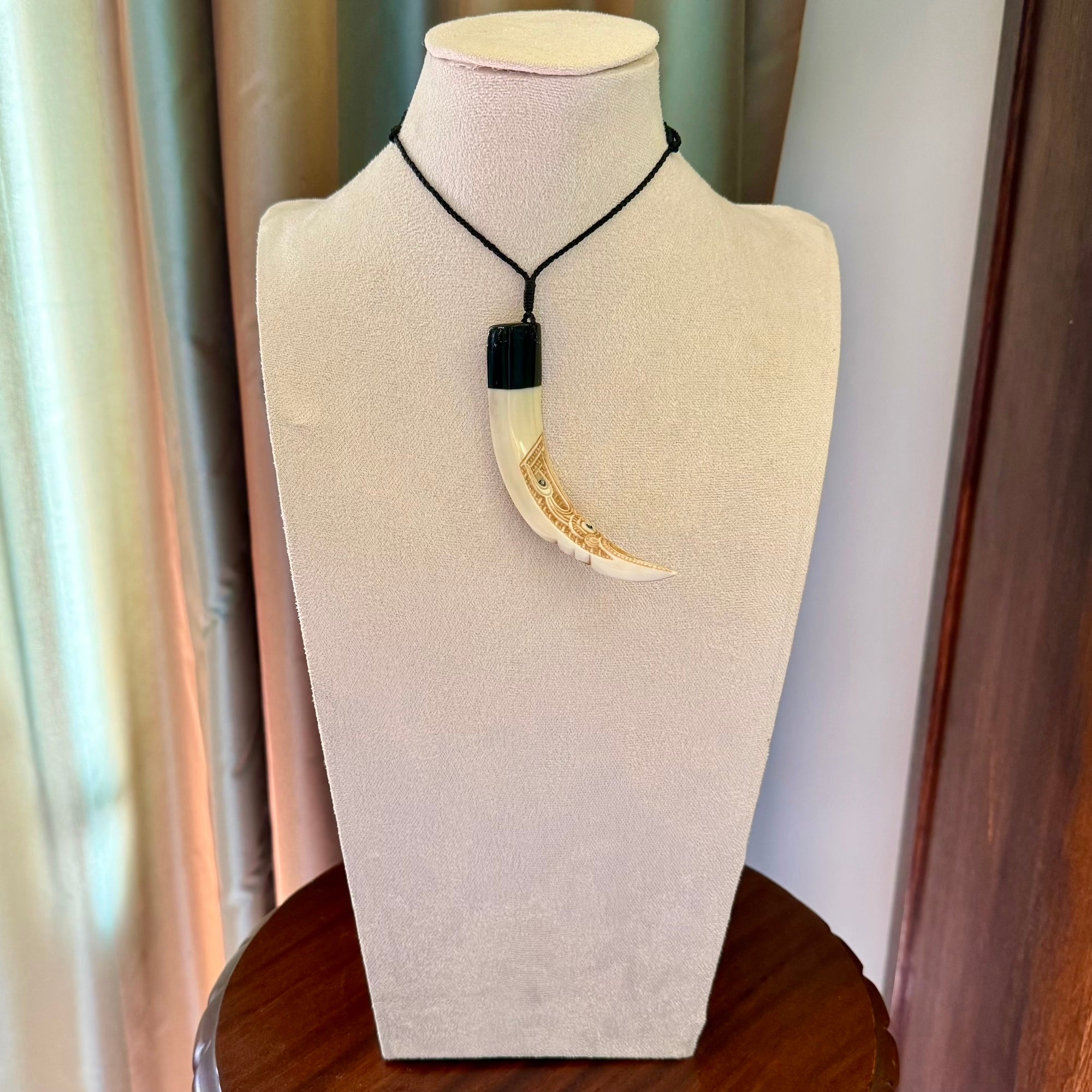 Hand carved Boars Tusk pendant with Buffalo horn and Paua Shell. Engraved large boars tusk pendant. Unisex necklace hand carved by Andrew Doughty here in New Zealand. Unique art to wear. Delivered with an adjustable black cord.