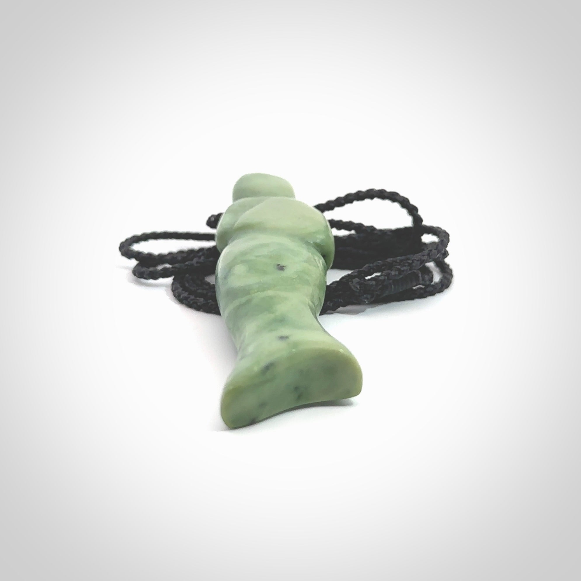 Hand carved New Zealand Jade woman drop pendant. Made by Ana Krakosky for NZ Pacific in New Zealand Pounamu, jade. A beautiful light green jade figure of a woman, drop necklace with black adjustable cord.