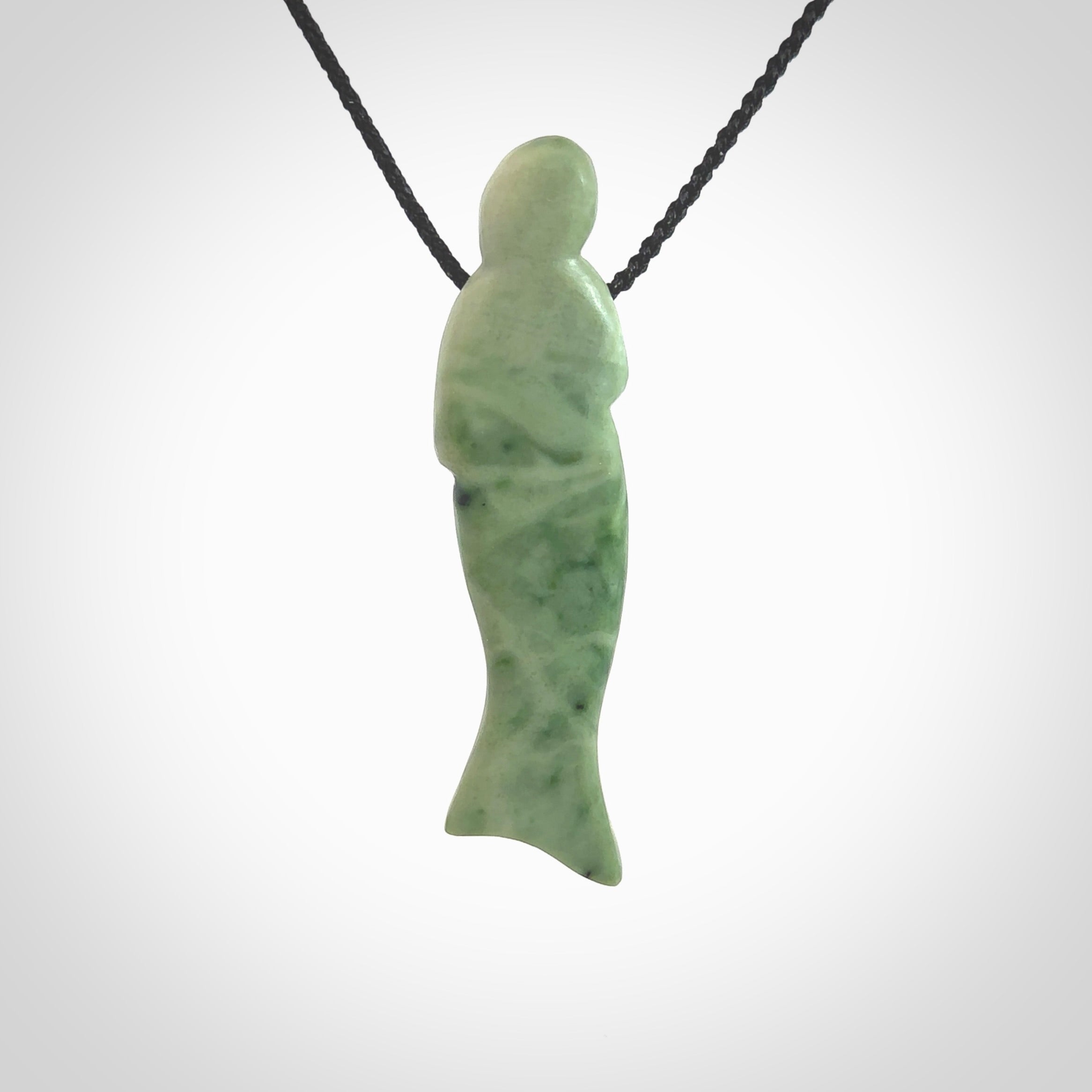 Hand carved New Zealand Jade woman drop pendant. Made by Ana Krakosky for NZ Pacific in New Zealand Pounamu, jade. A beautiful light green jade figure of a woman, drop necklace with black adjustable cord.