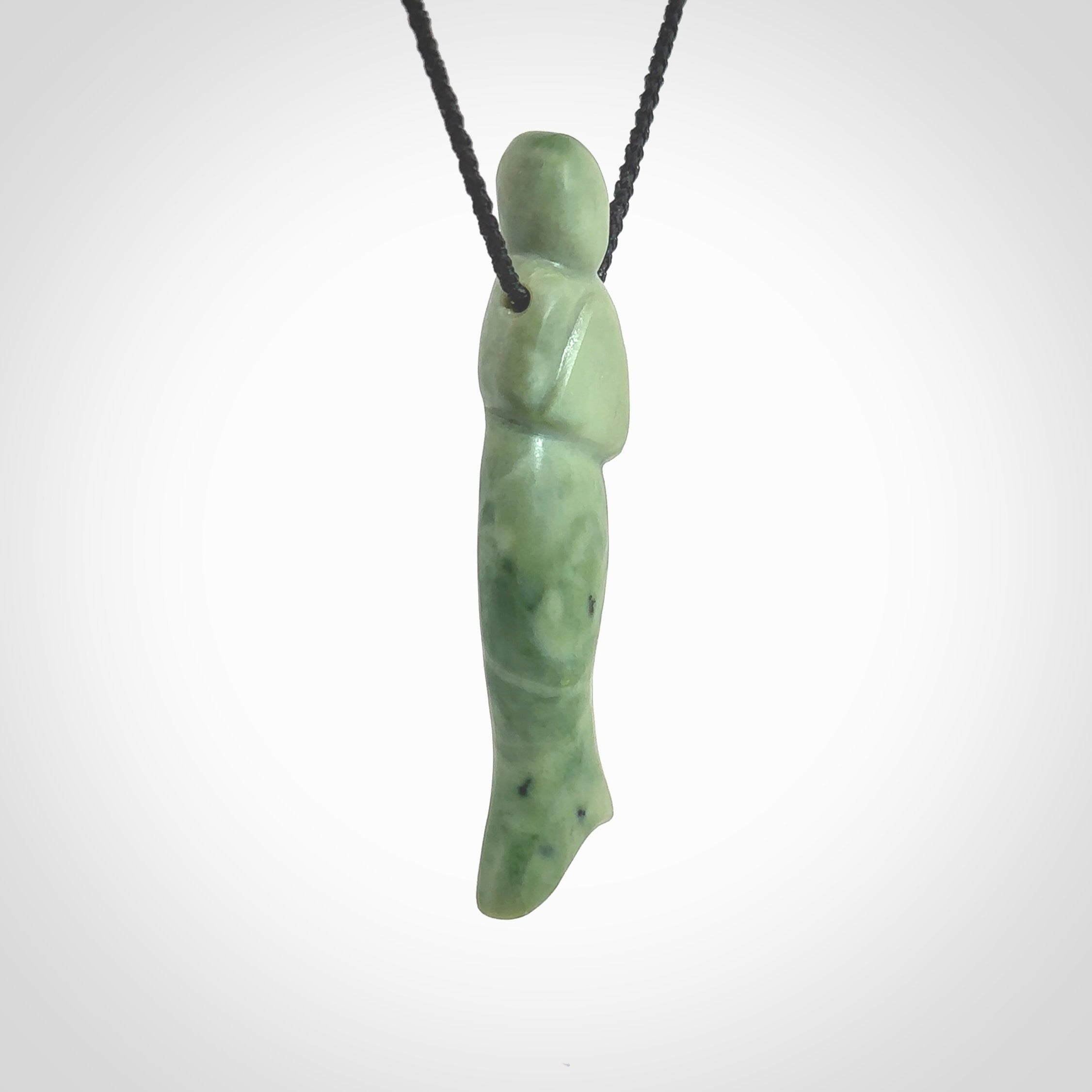 Hand carved New Zealand Jade woman drop pendant. Made by Ana Krakosky for NZ Pacific in New Zealand Pounamu, jade. A beautiful light green jade figure of a woman, drop necklace with black adjustable cord.
