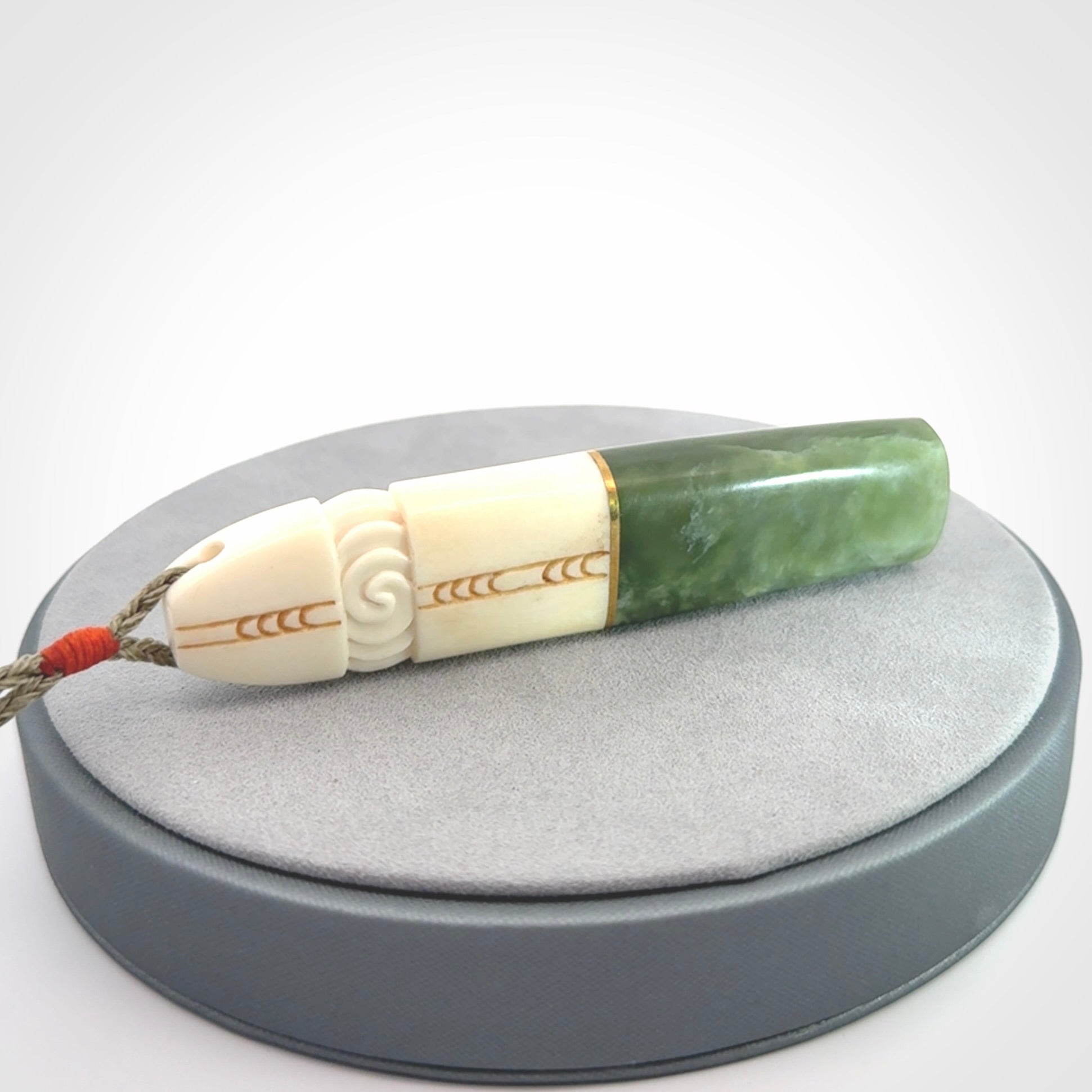 This is a wonderful New Zealand Jade and Bone drop pendant with brass inlay.