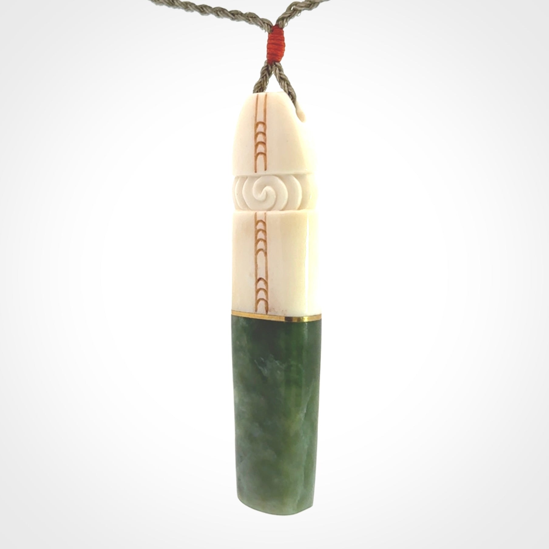 This is a wonderful New Zealand Jade and Bone drop pendant with brass inlay.