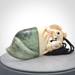 This is a large carved Kea pendant. It is made from three materials - New Zealand Jade, Bone, Brass.
