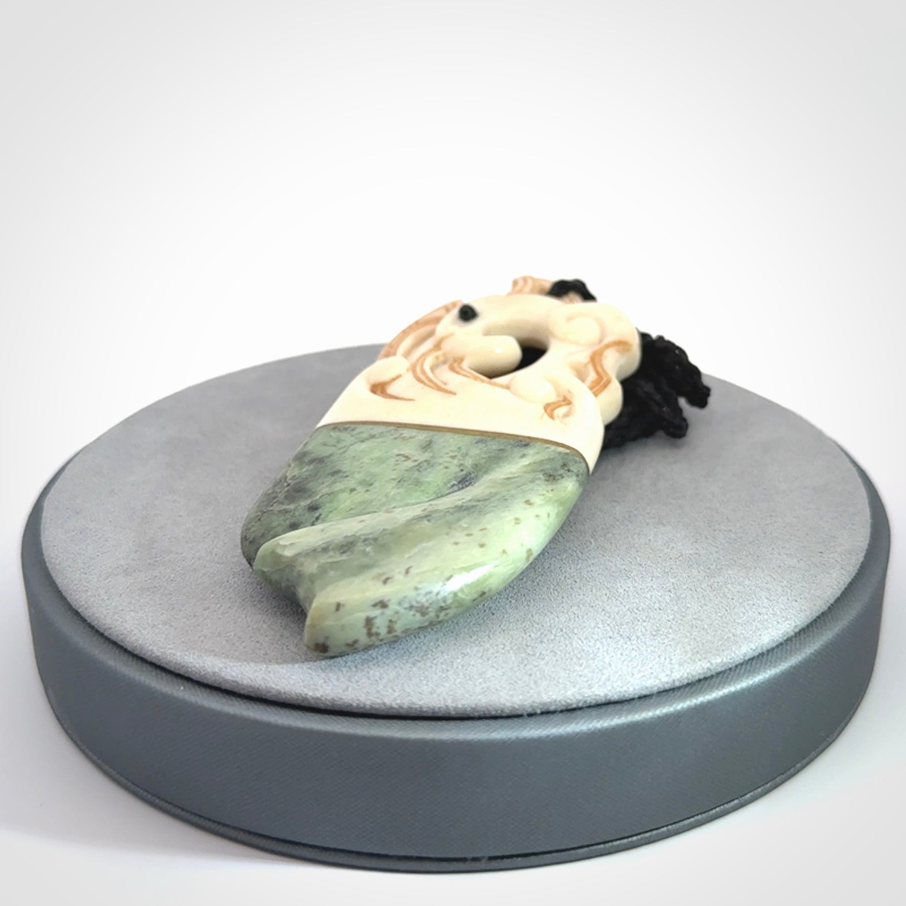 This is a large carved Kea pendant. It is made from three materials - New Zealand Jade, Bone, Brass.