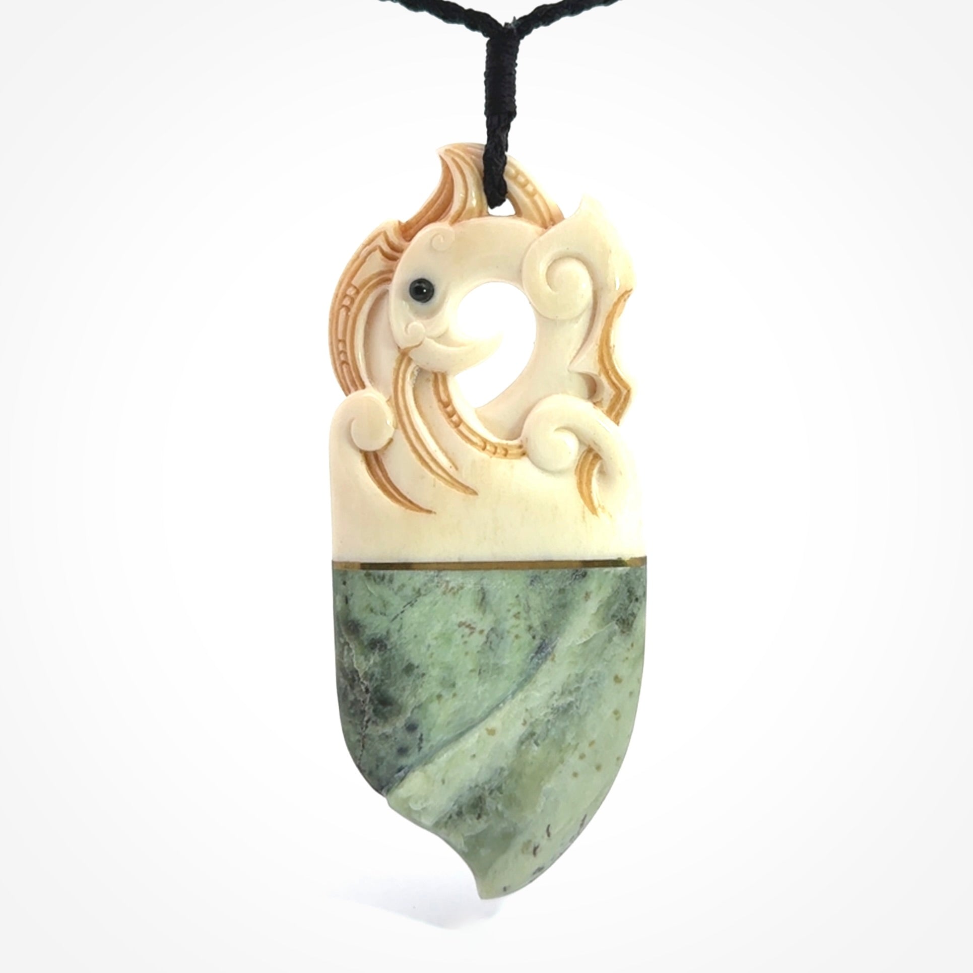This is a large carved Kea pendant. It is made from three materials - New Zealand Jade, Bone, Brass.