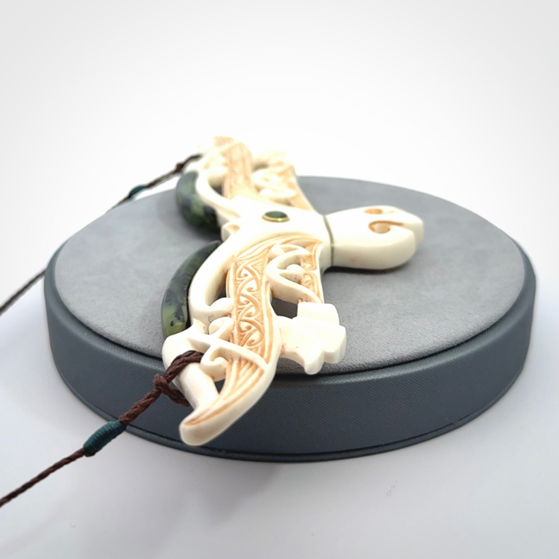 This is a wonderful New Zealand Jade and Bone necklace that can also be displayed as a sculpture with wooden stand.