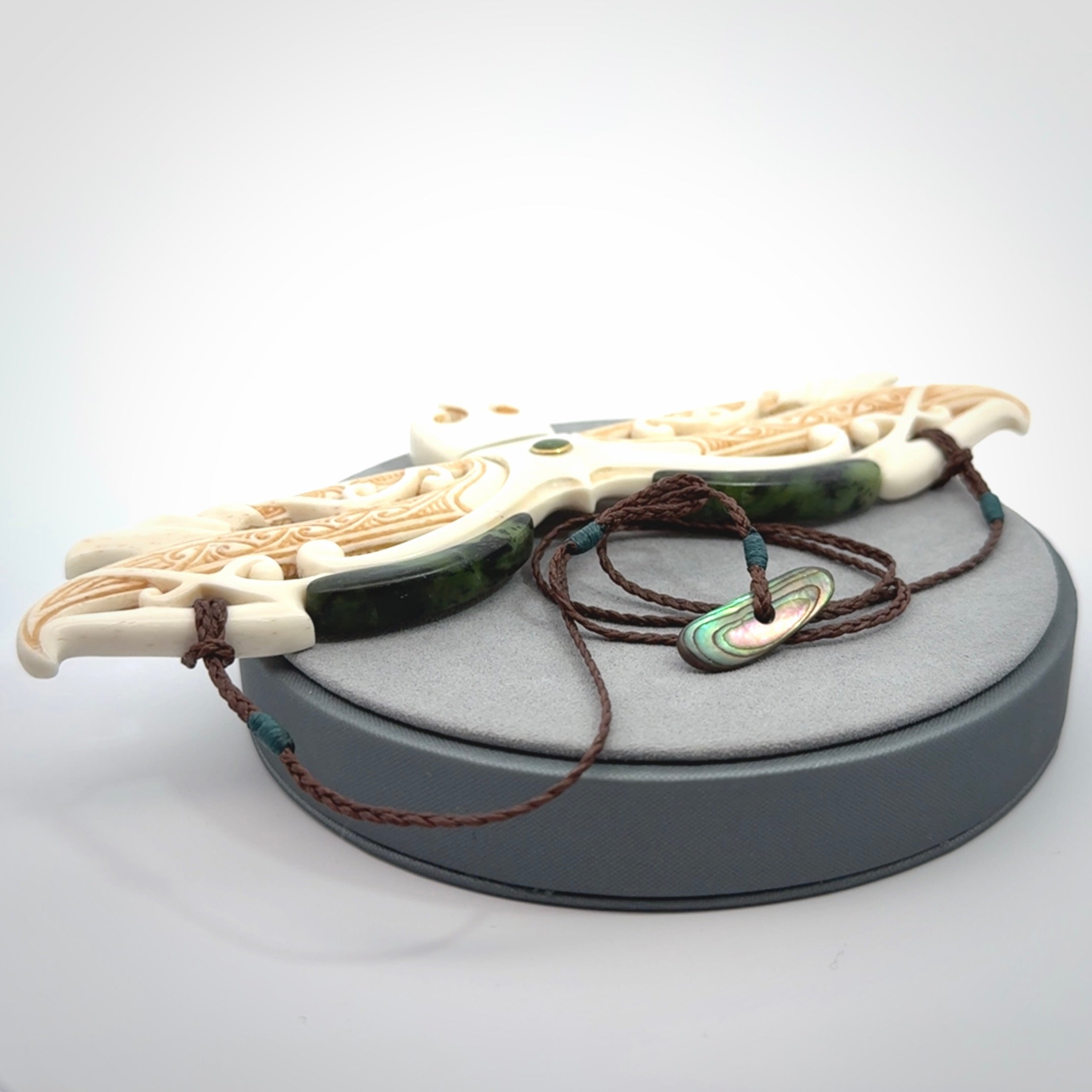 This is a wonderful New Zealand Jade and Bone necklace that can also be displayed as a sculpture with wooden stand.