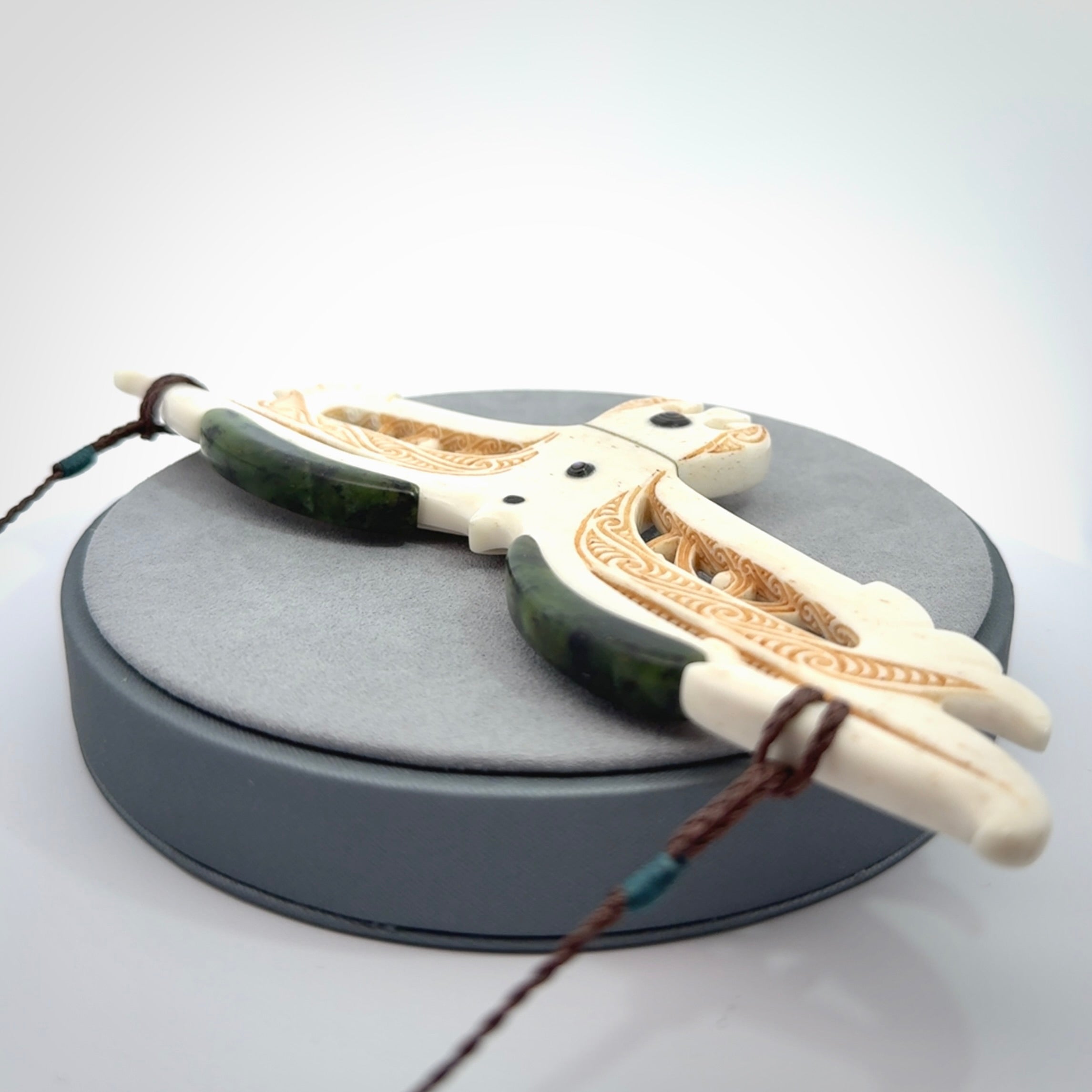 This is a wonderful New Zealand Jade and Bone necklace that can also be displayed as a sculpture with wooden stand.