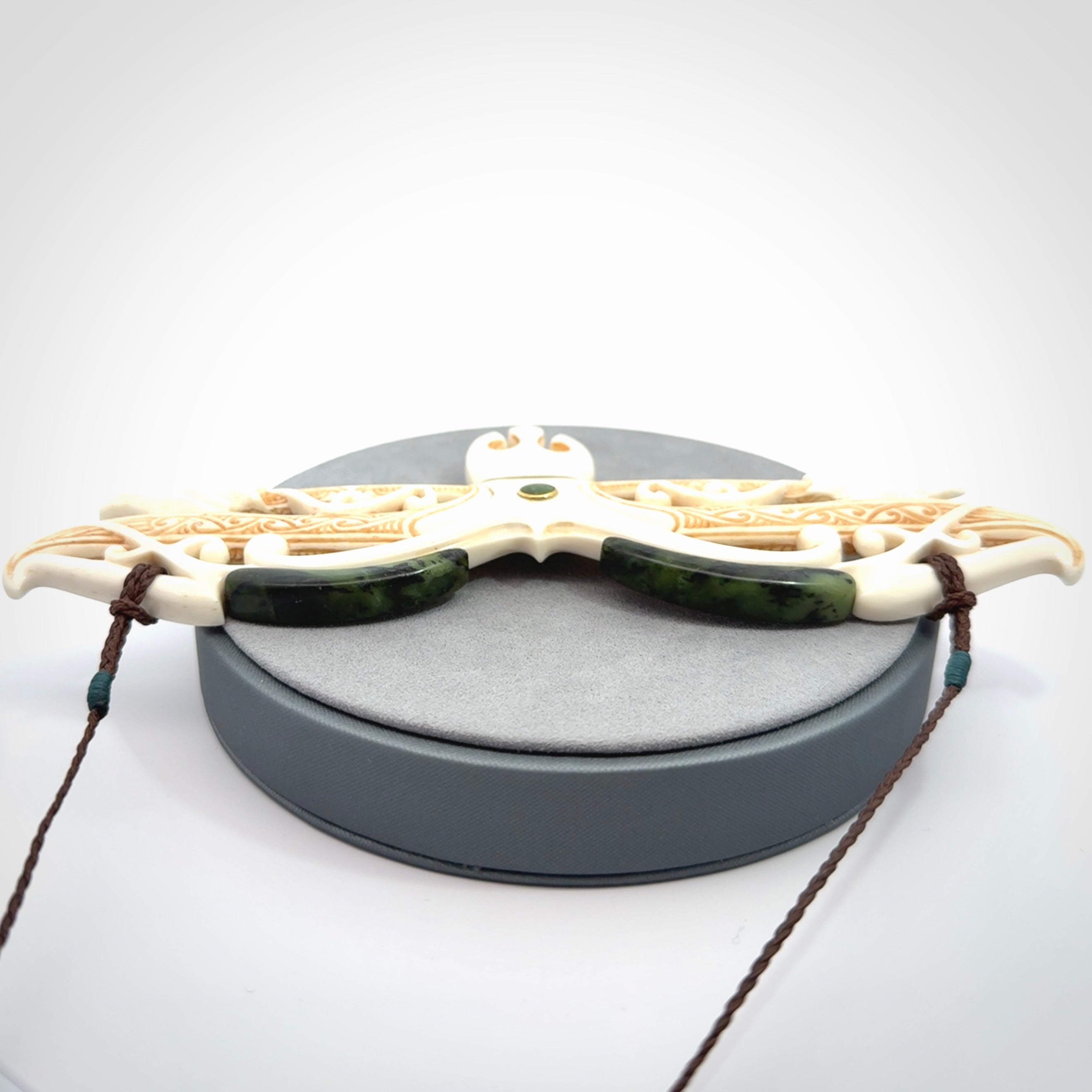 This is a wonderful New Zealand Jade and Bone necklace that can also be displayed as a sculpture with wooden stand.