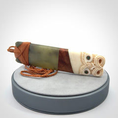 This is a large carved Koruru pendant. It is made from New Zealand Jade, Bone, Kauri wood and Brass. The face of the Koruru is carved with a traditional design in the front. It has a protruding tongue which is also carved and the back face has traditional carved designs. This is a large and very traditional pendant that is a collectors piece.