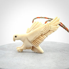This picture shows a carved kea pendant in bone. It is provided with a hand-plaited orange and olive cord that is length adjustable. Shipping is included and we ship worldwide.