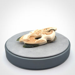This picture shows a carved manaia in bone with Jade and Paua shell. It is provided with a hand-plaited fern green cord that is length adjustable. Free shipping worldwide.