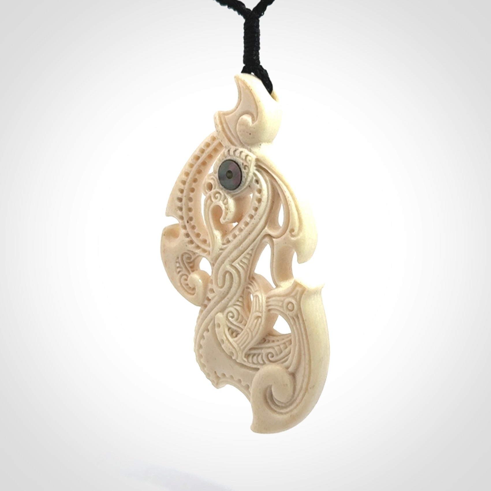 This is a wonderful, finely carved Manaia pendant. It is hand carved by Andrew Doughty and we will ship it to you free anywhere in the world. Hand made from whale bone and delivered to you with an adjustable black cord. Packaged in a woven kete pouch.
