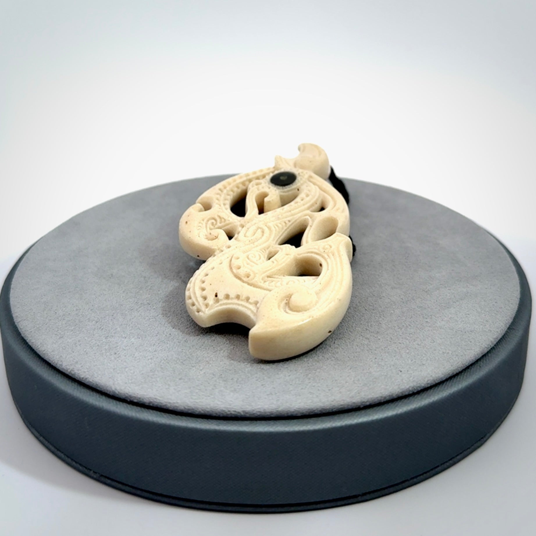 This is a wonderful, finely carved Manaia pendant. It is hand carved by Andrew Doughty and we will ship it to you free anywhere in the world. Hand made from whale bone and delivered to you with an adjustable black cord. Packaged in a woven kete pouch.