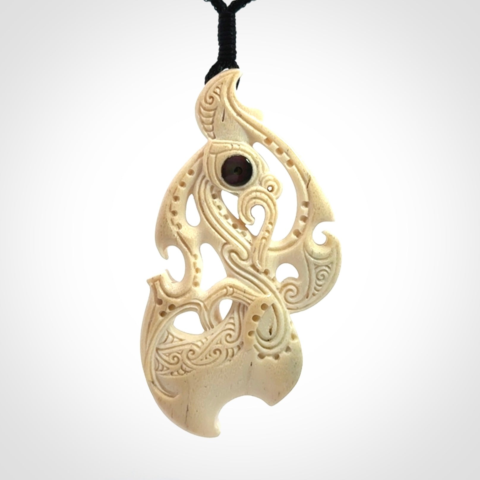 This is a wonderful, finely carved Manaia pendant. It is hand carved by Andrew Doughty and we will ship it to you free anywhere in the world. Hand made from whale bone and delivered to you with an adjustable black cord. Packaged in a woven kete pouch.