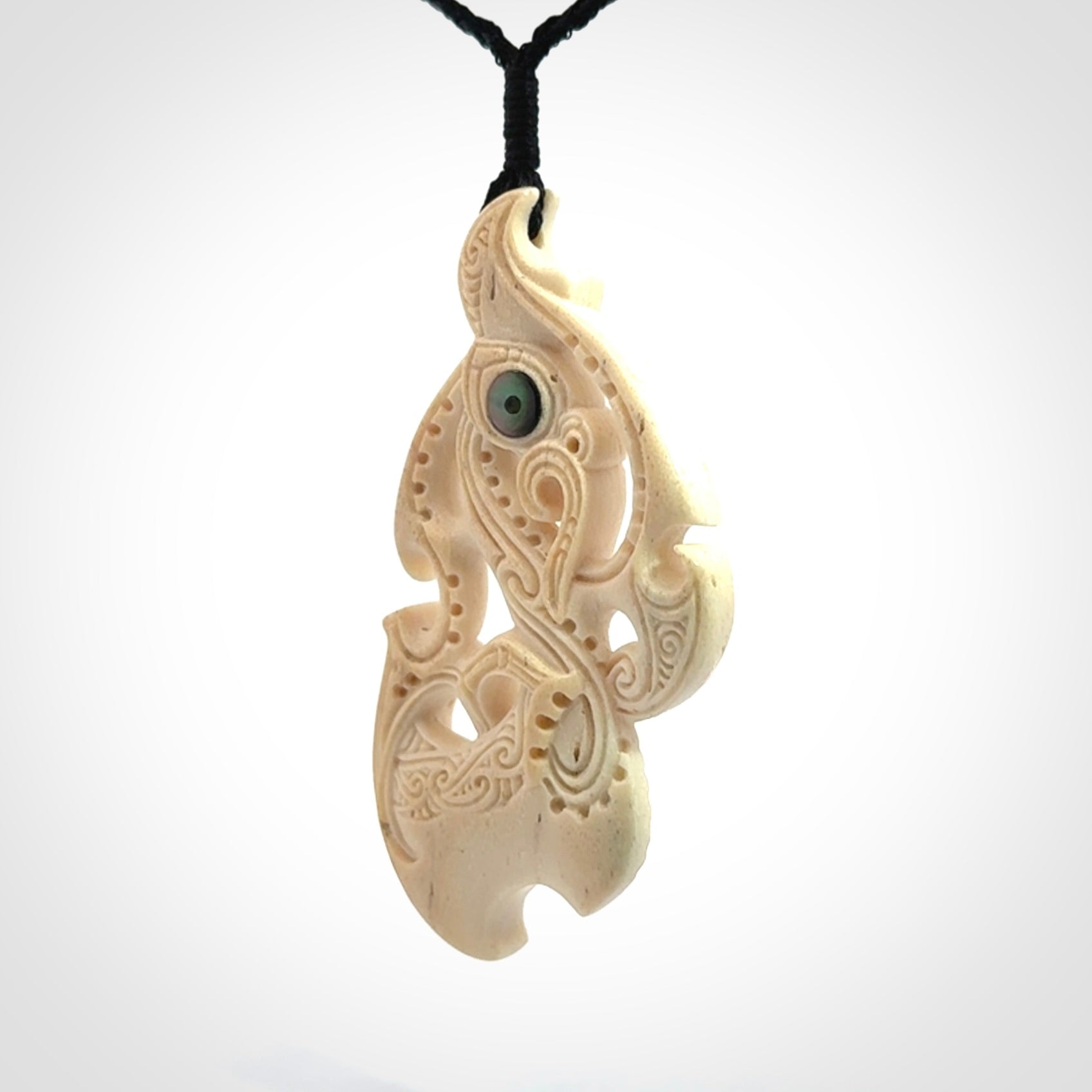 This is a wonderful, finely carved Manaia pendant. It is hand carved by Andrew Doughty and we will ship it to you free anywhere in the world. Hand made from whale bone and delivered to you with an adjustable black cord. Packaged in a woven kete pouch.